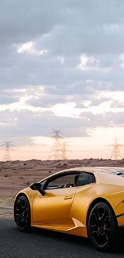 Yellow luxury sports car on desert road under cloudy skies.