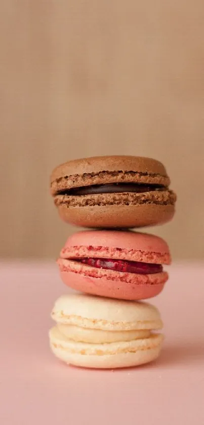 Stacked macarons on light pink background, perfect for dessert lovers.