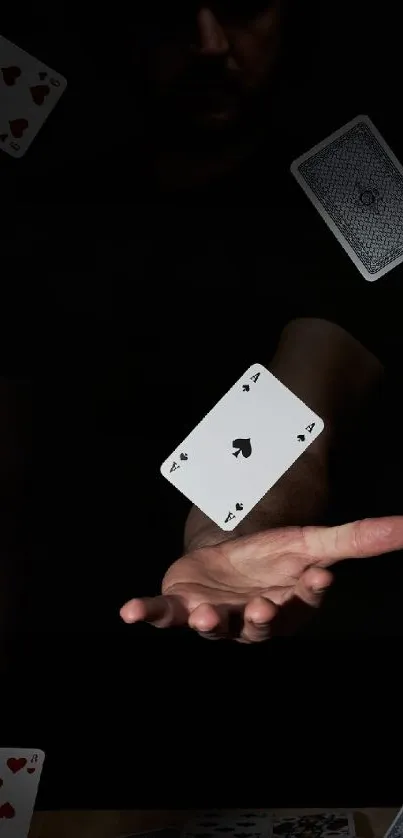 Hand and playing cards in magic trick wallpaper.