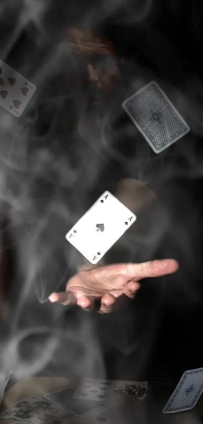 Magic hand with floating playing cards in misty dark scene.