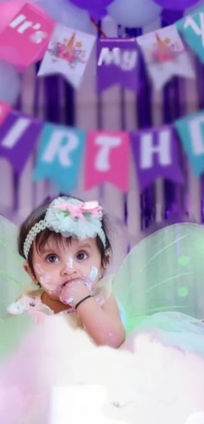 Baby in fairy outfit at a vibrant birthday celebration.