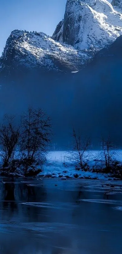 Snow-covered mountain reflecting in calm lake under blue sky.