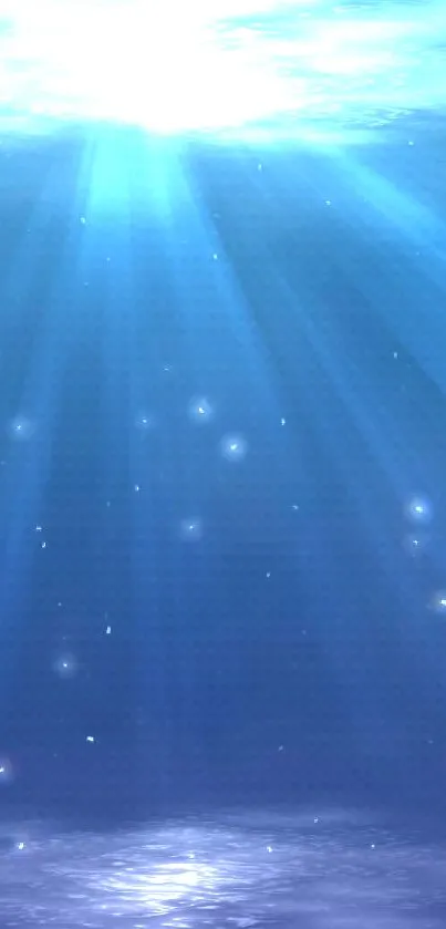 Blue ocean depth wallpaper with radiant light streaming underwater.