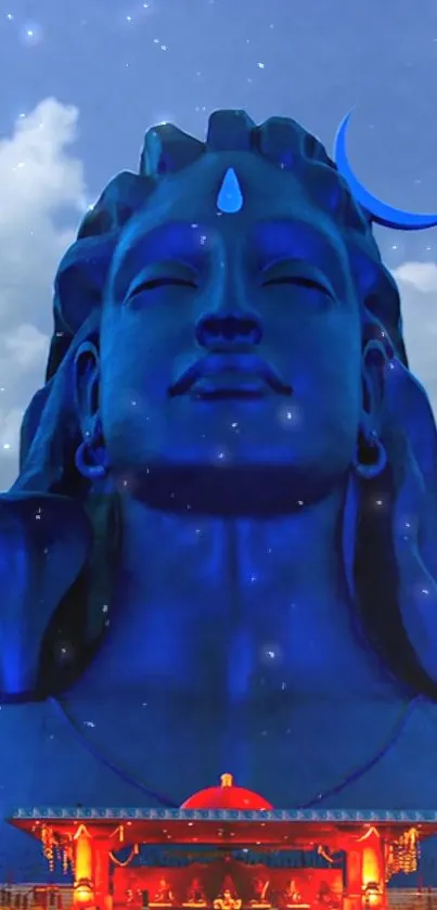 Majestic blue Shiva statue with serene sky.