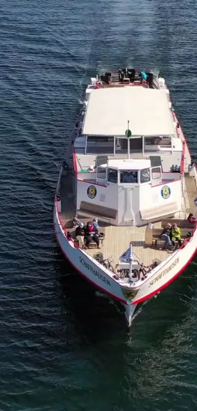 A boat gracefully sailing on deep blue waters, viewed from the sky.