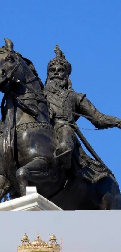 Bronze statue of a rider on a horse with a blue sky backdrop.