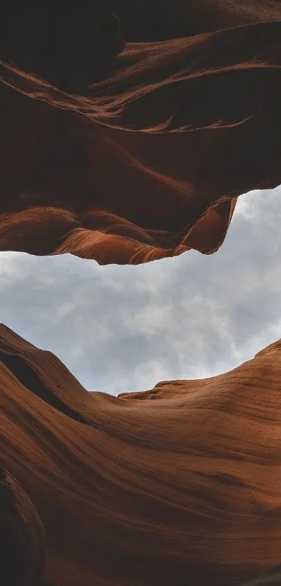 Majestic canyon view beneath a vast sky, showcasing natural rock formations.