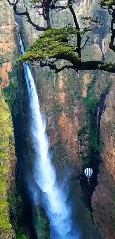 Majestic waterfall with hot air balloon over canyon.