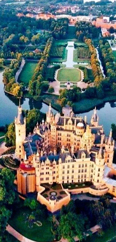 Aerial view of a majestic castle surrounded by lush greenery and water.