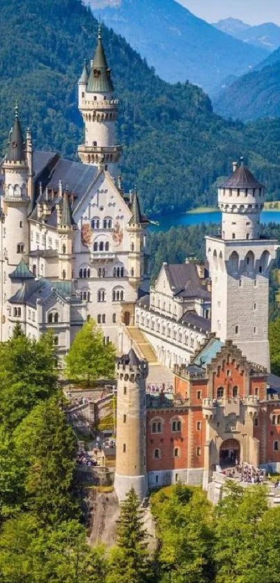 Majestic castle with mountain backdrop and lush greenery.