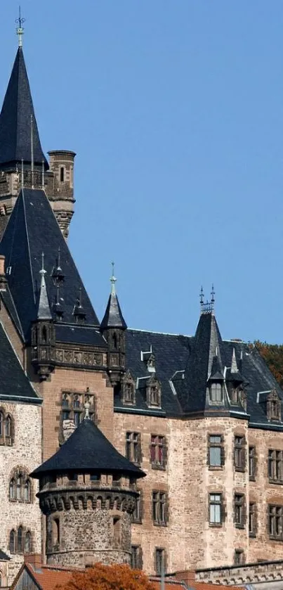 Medieval castle with turrets against a clear blue sky.