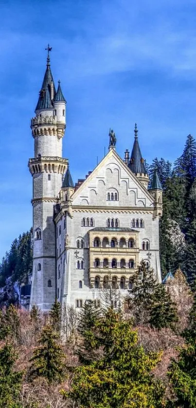 Majestic castle with a scenic forest backdrop under a vibrant blue sky.