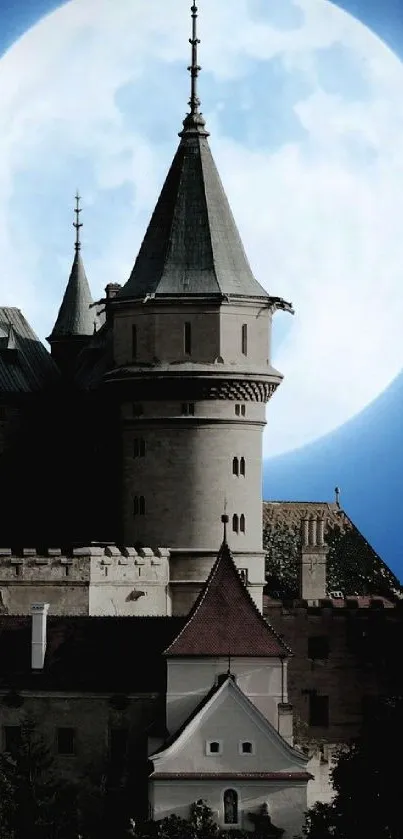 Castle under a bright full moon with dark silhouette.