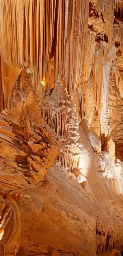 Majestic cave formation with stalactites and stalagmites in warm brown tones.