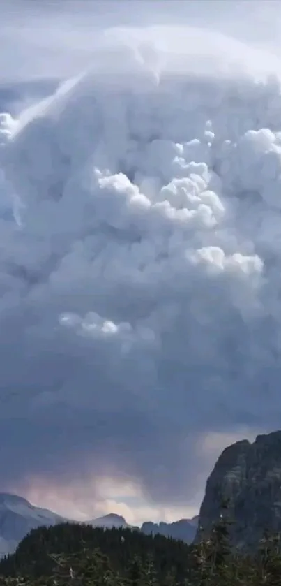 Dramatic clouds tower above a mountain landscape.