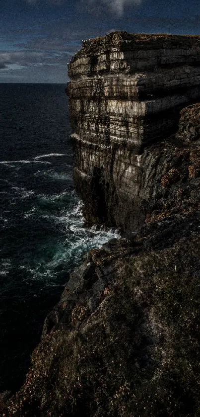 Dark and majestic coastal cliff with ocean view.