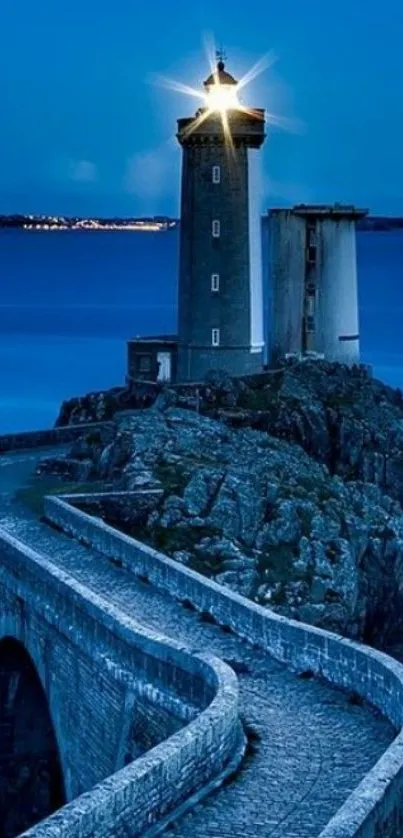 Lighthouse with blue ocean at night.