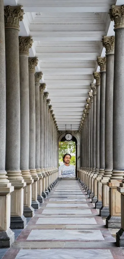 Majestic corridor with tall columns leading to an archway.