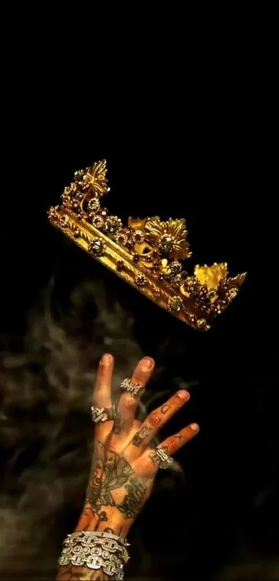 Tattooed hand reaching for a golden crown against dark backdrop.