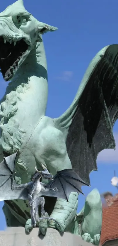 Dragon sculpture with bat wings under blue sky.