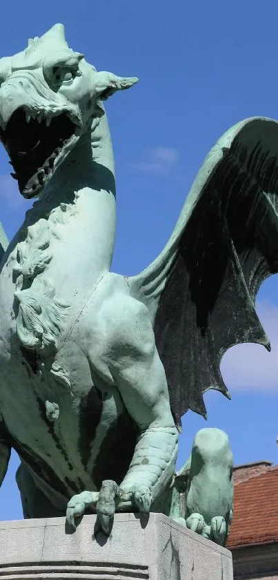 Majestic dragon statue with wings under a clear blue sky.