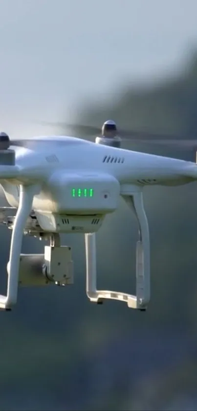 White drone flying over a blue-gray background, capturing technology in nature.