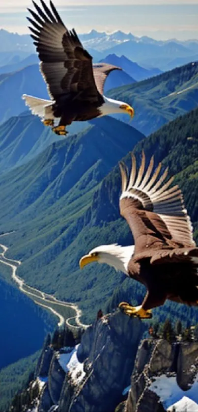 Two eagles soar above mountain peaks against a vivid blue sky.