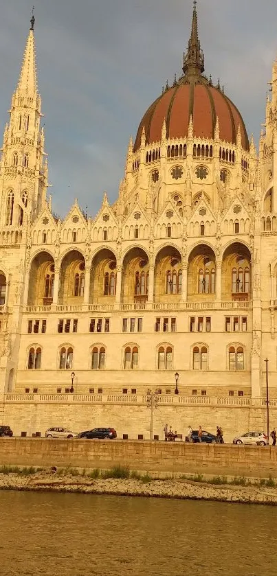 European architectural building by the river at sunset with a golden glow.