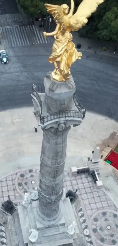 Golden angel statue on a tall column viewed from above.