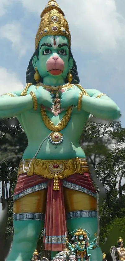 Statue of Hanuman set in a green landscape.