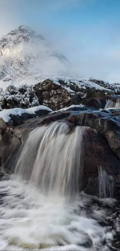 Majestic Highland waterfall with snowy mountains backdrop.