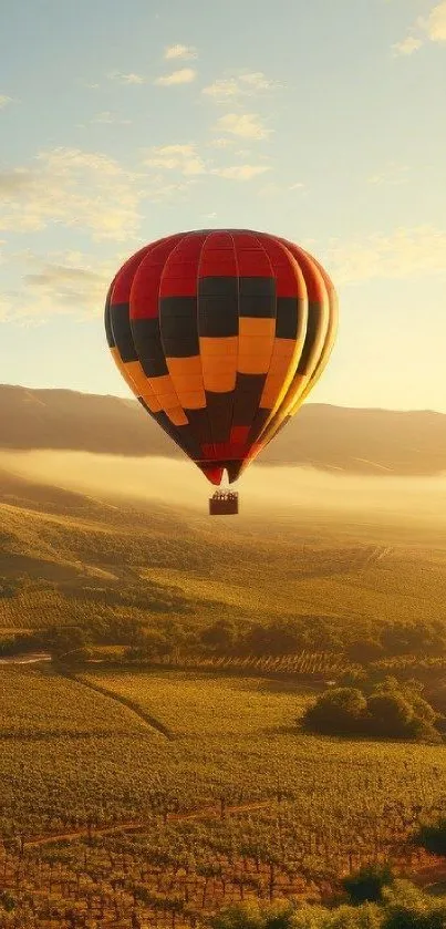 Colorful hot air balloon drifting over sunlit hills and valleys.