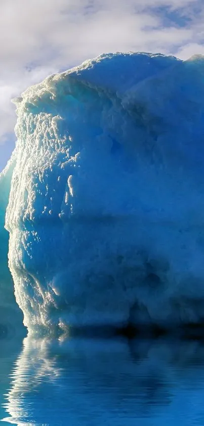 Serene blue iceberg reflecting on calm ocean water.