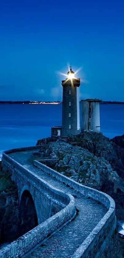 Majestic lighthouse overlooking ocean at twilight with rocky path.