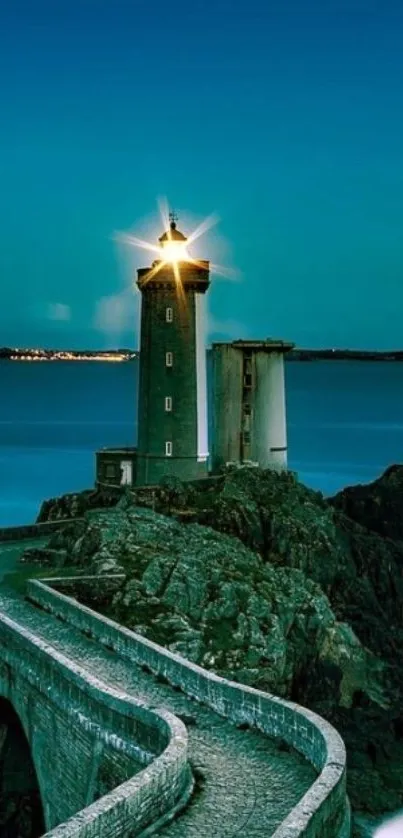 Lighthouse standing tall against a teal sky overlooking the ocean.