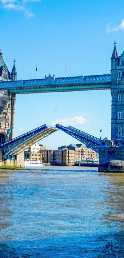 Tower Bridge in London over River Thames under a bright blue sky.