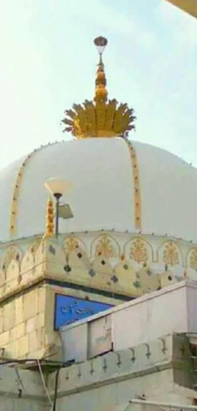 Majestic marble dome with golden details under sunlight.