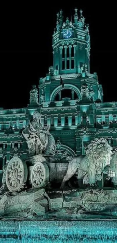 Historic monument illuminated in teal light at night, featuring statues and architecture.