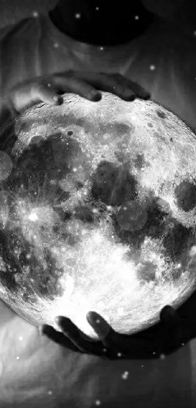 Black and white image of moon held in hands, creating a mystical ambiance.