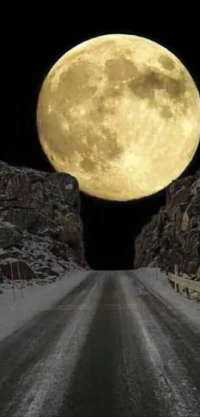 Wallpaper of a full moon rising above a road flanked by rocky cliffs.