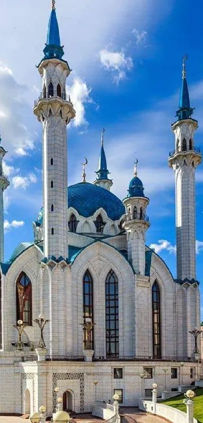 Majestic mosque with blue domes and tall minarets under a clear sky.