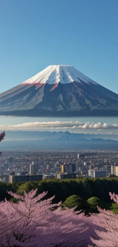 Mount Fuji with cherry blossoms and cityscape, under a clear blue sky.