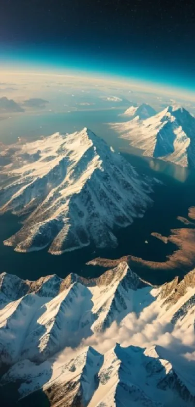 Breathtaking aerial view of towering snow-capped mountains and blue horizon.