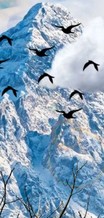 Snowy mountains with birds flying in the sky.