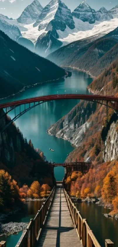 Scenic mountain bridge with autumn colors and snowy peaks.