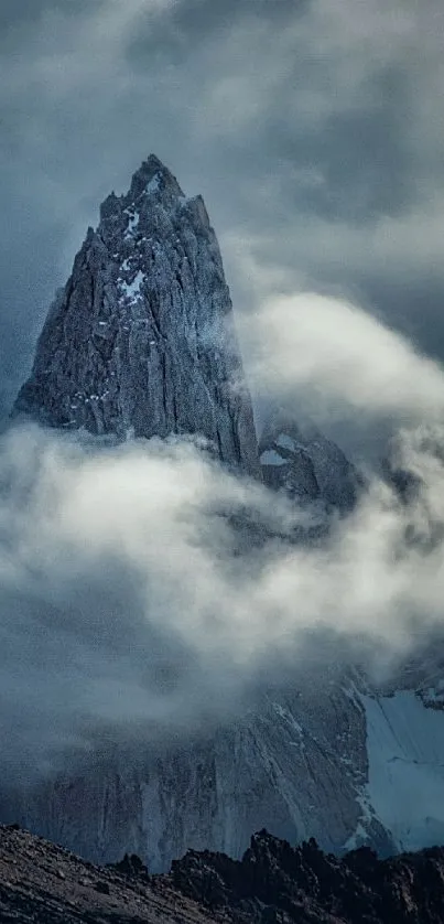 Mountain peak enveloped in mist and clouds, showcasing natural beauty.