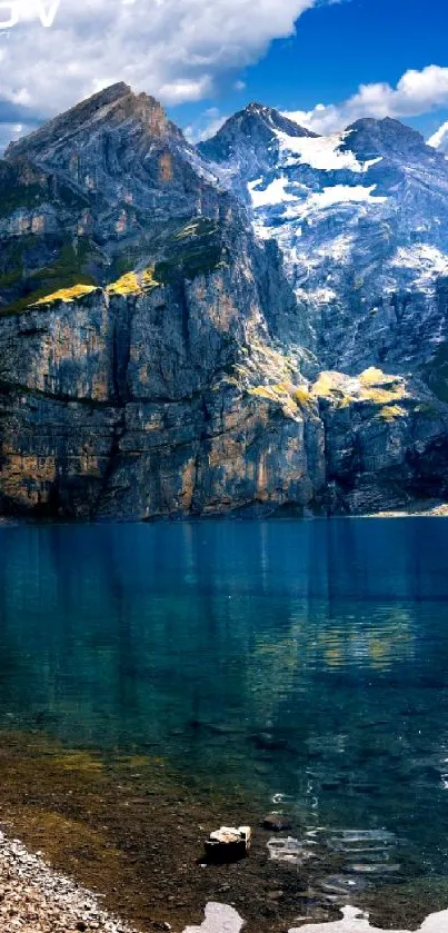 Breathtaking mountain lake with rocky peaks and clear blue water under bright skies.