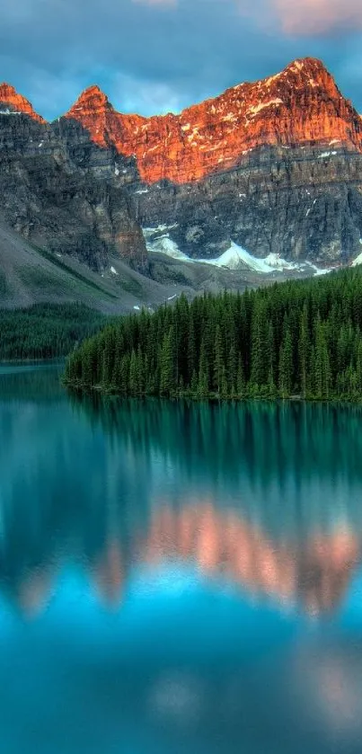 Scenic mountain lake with sunset reflections and pine trees.