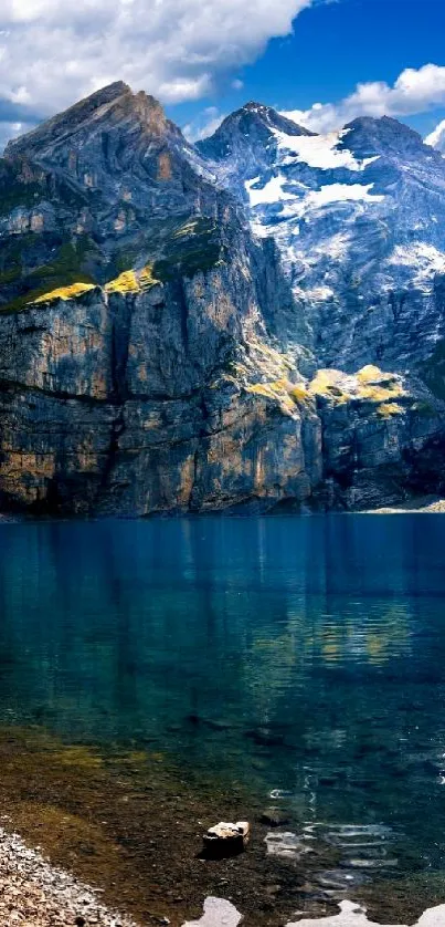 Majestic mountain lake with clear blue-green water and towering peaks.