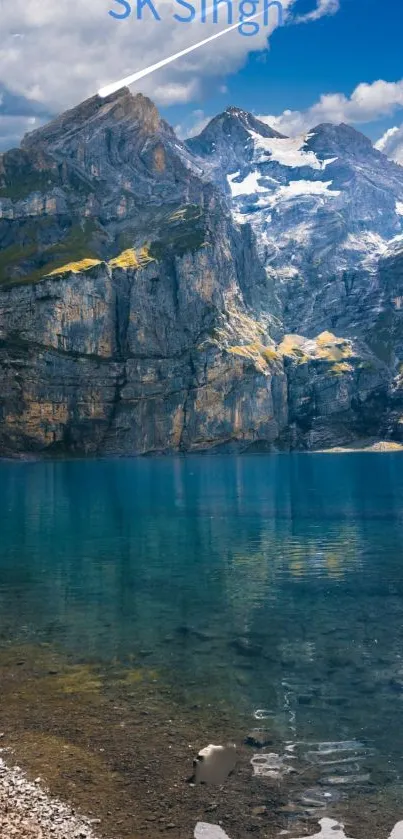 Scenic view of a mountain lake with rugged cliffs and clear blue sky.